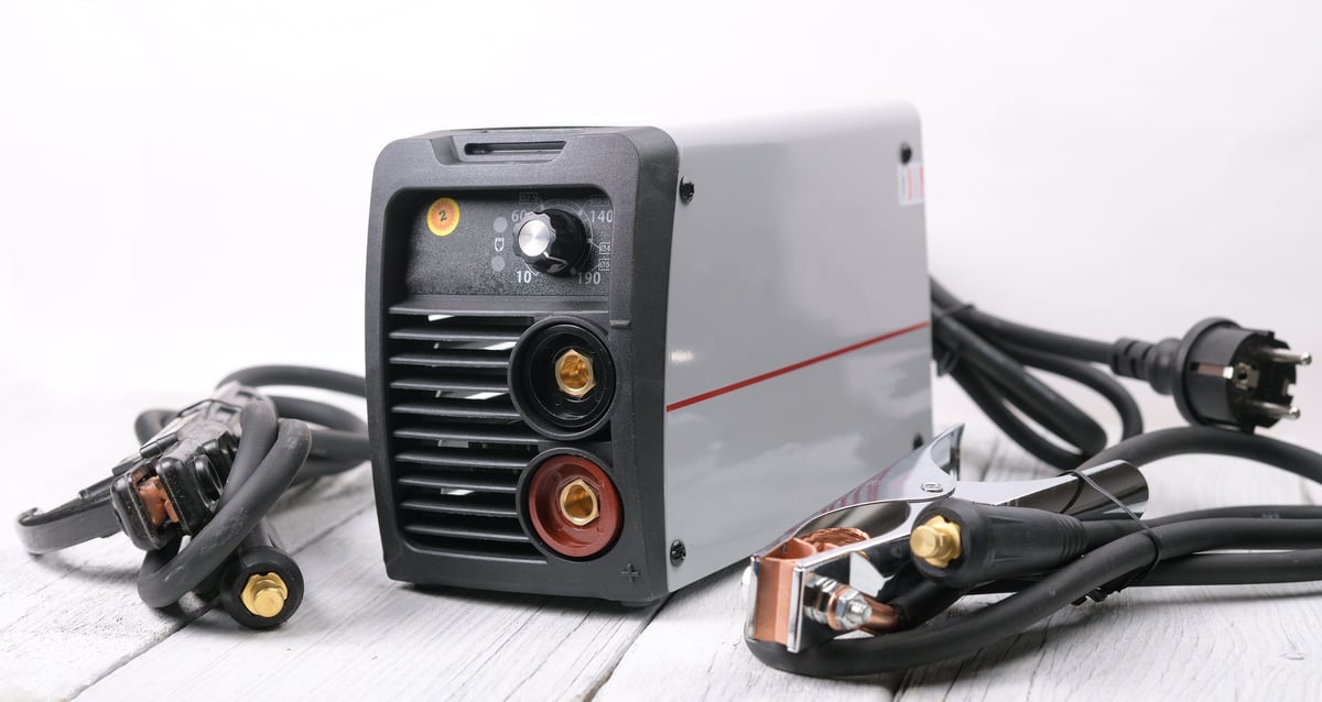 Welding inverter machine with terminals stands on the table.